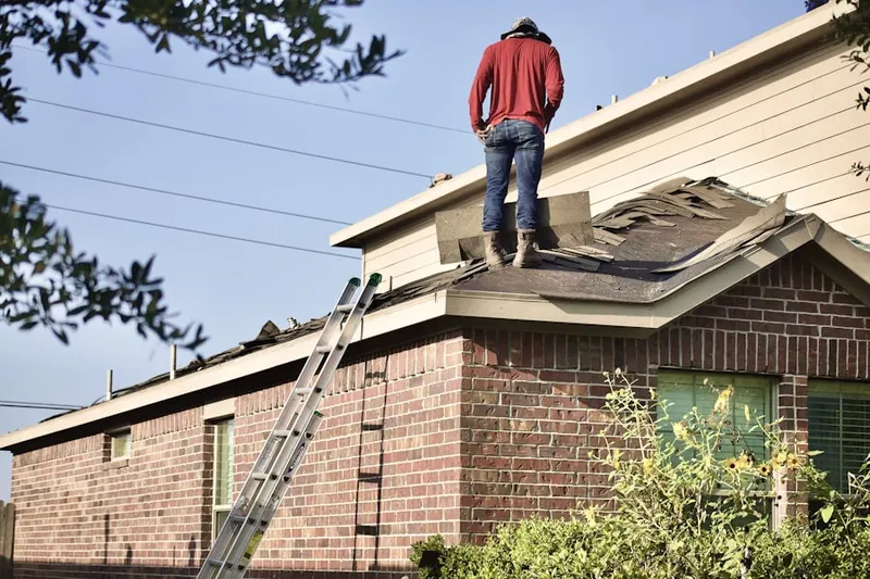 Professional roofer working on a residential roof in The Jungle